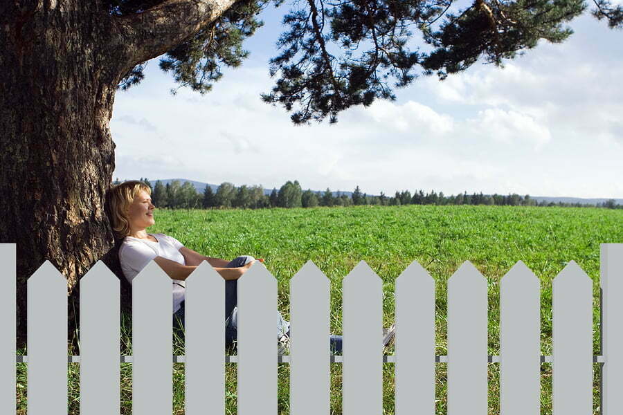 woman sitting alone under a tree