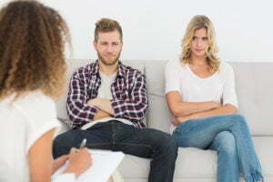 Unhappy couple not talking on the couch at therapy session