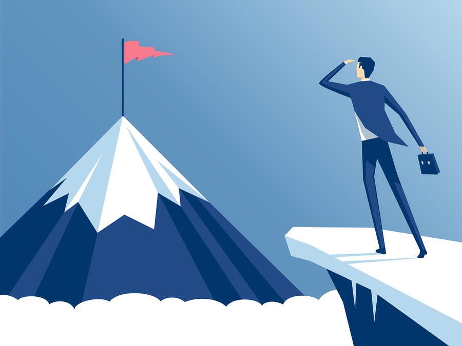 man looking at mountain peak